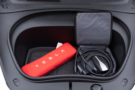 Lviv, Ukraine - March 23, 2024: Front trunk of White Tesla Model 3 highland electric vehicle , front trunk details. Open front trunk of a Tesla Model 3 highland in showroomのeditorial素材