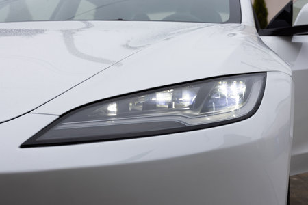 Lviv, Ukraine - March 23, 2024: New Tesla Model 3 highland electric car closeup of super bright and modern LED matrix headlight lamps. Front matrix headlights. Headlight of modern luxury carのeditorial素材