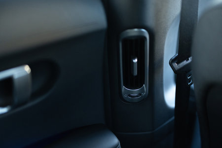 Interior details of a modern car Close-up view of car air vents. Air ventilation for rear passengers. Deflectors for rear passengers. Climate control rear passengers, air ducts on car panelの写真素材