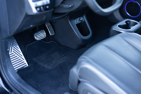 Electric car interior details. Vehicle Gas Brake Pedal, car pedals. Detailing of modern electric car, Brake and accelerator pedal of electric car interior. Brakes and accelerator pedals EV vehicle.の写真素材
