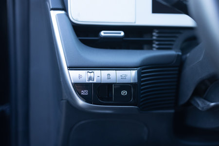Auto hold button in a modern vehicle. ESP electronic stability program control. Interior detail of a...
