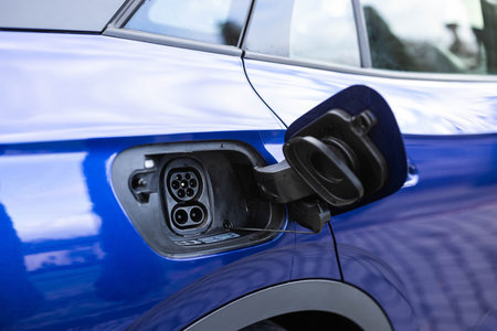 Fast charging socket type 2 combo electric car. Type 2 CCS plug port on electric vehicle. DC - CCS type 2 EV charging connector at EV car. Eco friendly alternative energy green environment concept.の写真素材