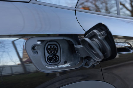 Fast charging socket type 2 combo electric car. Type 2 CCS plug port on electric vehicle. DC - CCS type 2 EV charging connector at EV car. Eco friendly alternative energy green environment concept.の写真素材