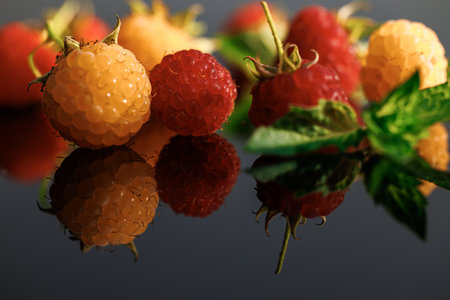 Raspberry with leaves. Fresh red ripe raspberries. Delicious fresh raspberries isolated on black background.. Sweet ripe fresh delicious raspberry, summer berry, organic food, vitaminsの写真素材