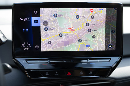 Displaying dashboard controls is an electric car charging station. On the screen is map with the...