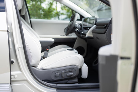 Interior of prestige modern electric car. Leather comfortable seats, dashboard and steering wheel. Car interior luxury. Cockpit with exclusive decorationの写真素材