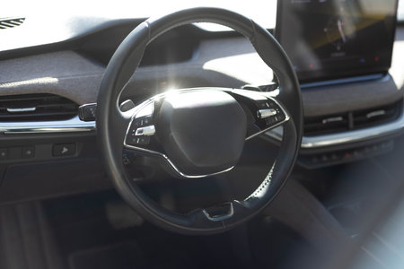 Steering wheel of electric vehicle, interior, cockpit, electric buttons. Autonomous car. Driverless...