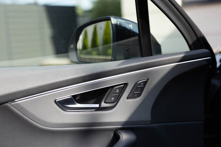 Control buttons for settings and memory of the drivers seat, electric glass opening, door handle in the interior of the new luxury electric car.の写真素材