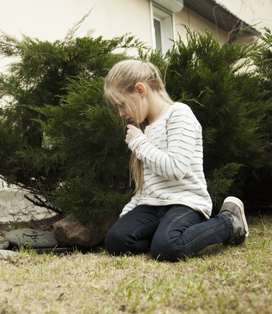Girl hiding in green bushes and juniperの写真素材