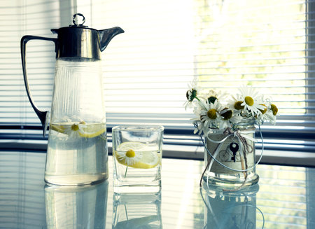 ancient jug with silver with a summer drink of lemon