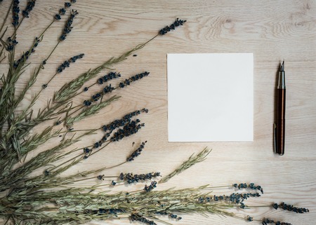dried lavender and pen on a wooden backgroundの写真素材