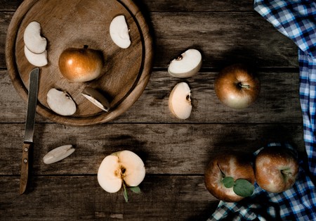 vintage. fruit. ripe apples, old knife and a kitchen towel on the old wooden table. Top viewの写真素材