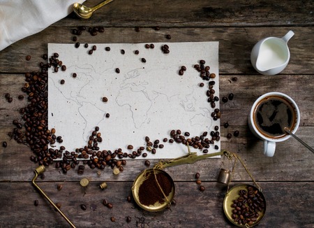 map of the world, lined with coffee beans on old paper.の写真素材