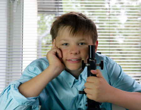 boy with a microscope in a laboratory