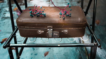 old leather suitcase on a turquoise backgroundの写真素材