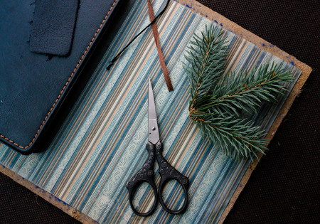 notebook, fir branch and scissors on the old paper. top viewの写真素材