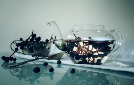 still life. bunches of wild grapes in a glass pot.の写真素材