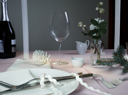 elegant table setting. Christmas. romantic dinner - a table with a tablecloth, cutlery, candles, flowers, budsの写真素材