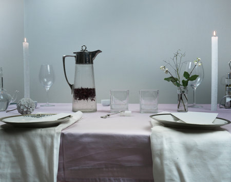 table setting. romantic dinner, flowers in a vase, candles, compote of barberry