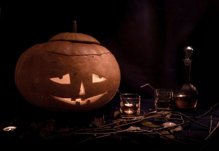 Funny Halloween pumpkins drinking wine at black backgroundの写真素材