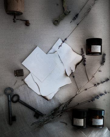 Sheets burnt paper, cans and bottles, old keys, dry lavender. view from above.