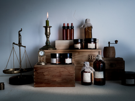 pharmacy. bottles, jars candle on wooden shelvesの写真素材