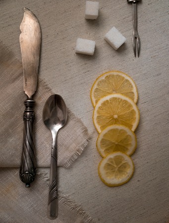 vintage silver cutlery, lemon and refined on canvasの写真素材
