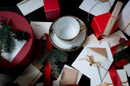 ancient antique cup on the Christmas table with presents, clock, letters, envelopes and invitations