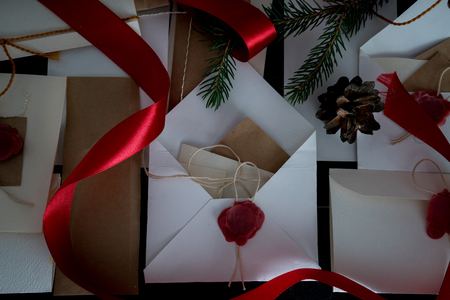 Christmas background with clock, snow fir tree and gift boxes over wood. letters invitationsの写真素材