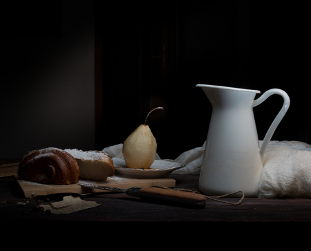 still life. pears and old books on a dark background. old painting.の写真素材