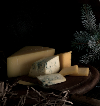 hard cheese, bunch on wooden table. black backgroundの写真素材
