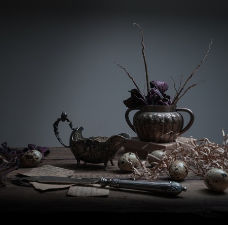 collection of antique silver items on a wooden table. black backgroundの写真素材