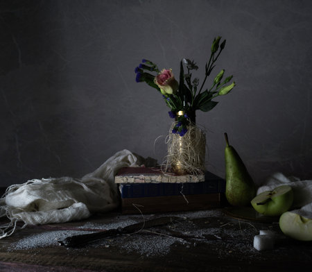 vintage. old books, bouquet of flowers, drapery on a wooden table. dark backgroundsの写真素材