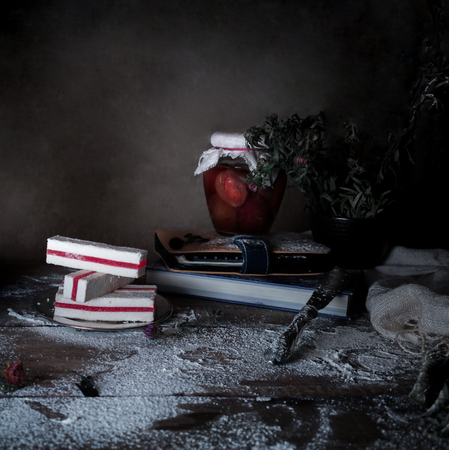 rustic still life, vintage. dark background. plum jam in the pot, dessert with plums on a wooden table.の写真素材