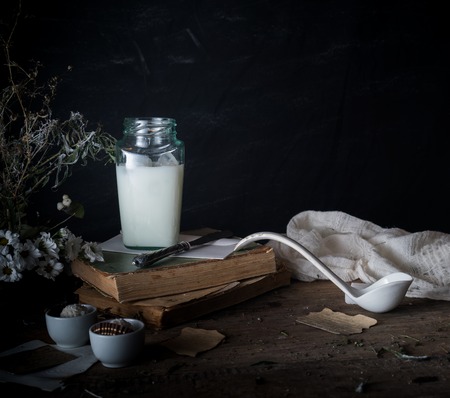 rustic breakfast. still life, vintage. the book chrysanthemums, the milk bank. space for text. black backgroundの写真素材