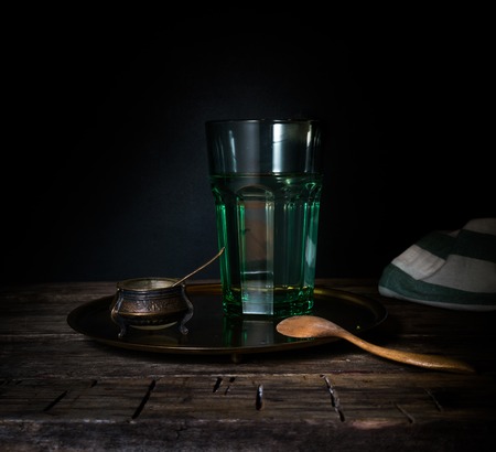 Glass glass with water on a wooden table. Dark backgroundの写真素材