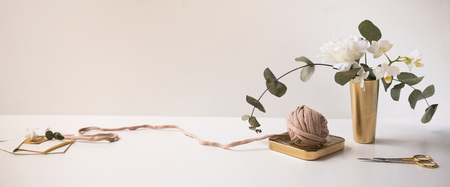 Header, banner for site design. Needlework, handmade. Orchid, eucliptus, knitting and crocheting, yarn. Horizontal format, space for textの写真素材