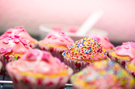 Glazed cupcakes with sprinkles and Kchengerten in the backgroundの写真素材