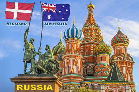 Flags of Denmark and Australia being held by two warriors on a statue in front of a Saint Basil's Cathedral in Moscow, Russiaの写真素材