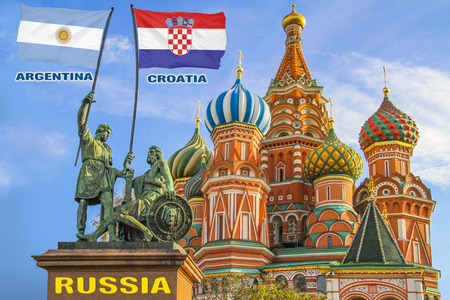 Flags of Argentina and Croatia being held by two warriors on a statue in front of a Saint Basil's Cathedral in Moscow, Russiaの写真素材