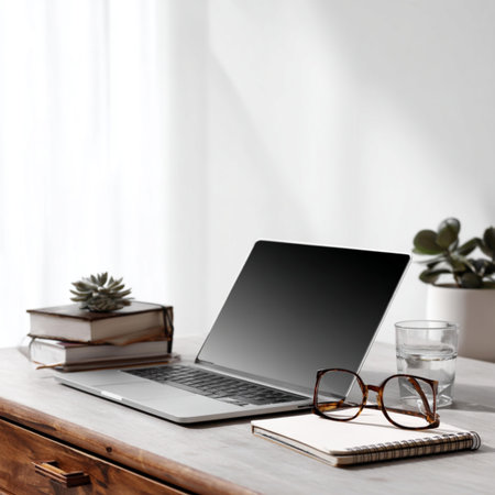 Modern workplace with laptop, books and glasses on wooden table. Mock upの写真素材