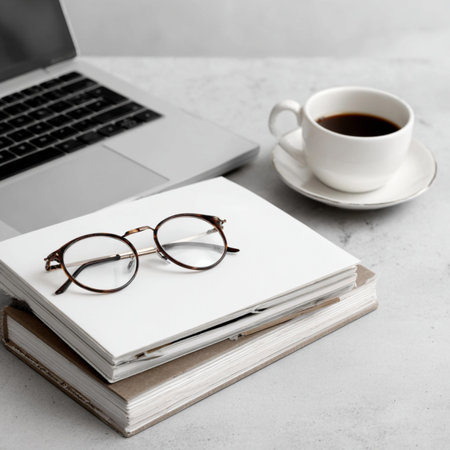 Laptop, books and glasses on a white background. Business concept.の写真素材