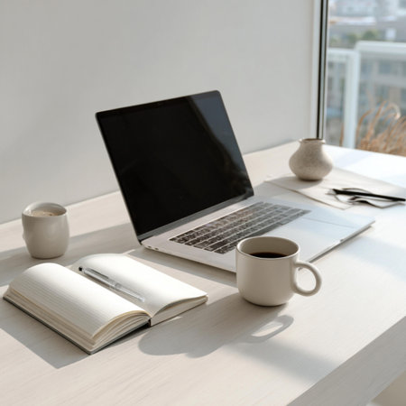 Workplace with laptop, cup of coffee and notebook on table in officeの写真素材