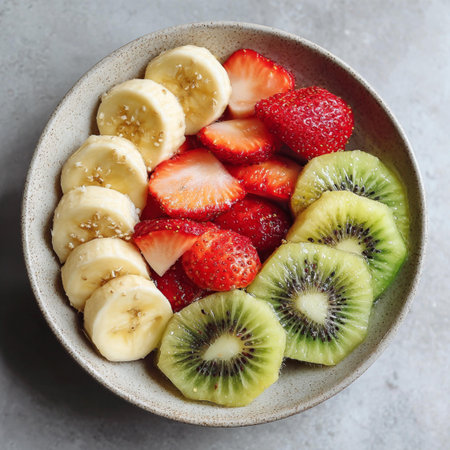 Fruit salad with kiwi, banana and strawberry in a bowlの写真素材