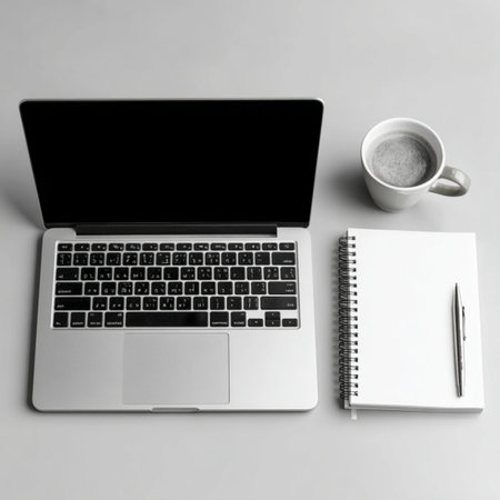 Laptop, notebook and cup of coffee on grey background, top view