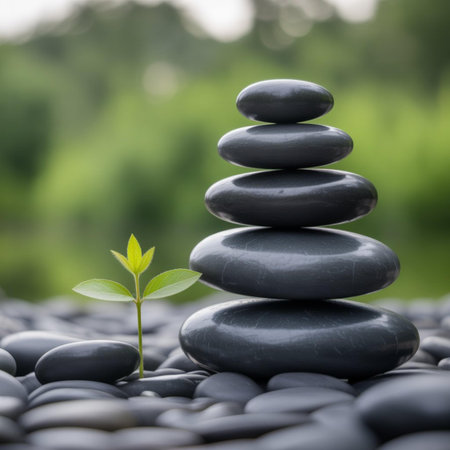zen stones and green plant on the pebble background, nature concept