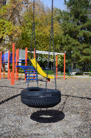 Old tyre recycled and reused as a swingg in a children playgrund