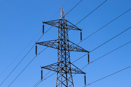 A power line tower with a blue sky in the backgroundの写真素材