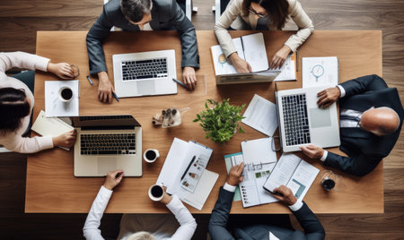 Collaborative Coding: A Group of Technologists Engaged in Laptop-based Workの素材