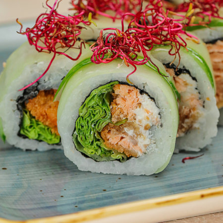 A plate with a variety of fresh sushi rolls, neatly arranged and ready to be enjoyed.の写真素材
